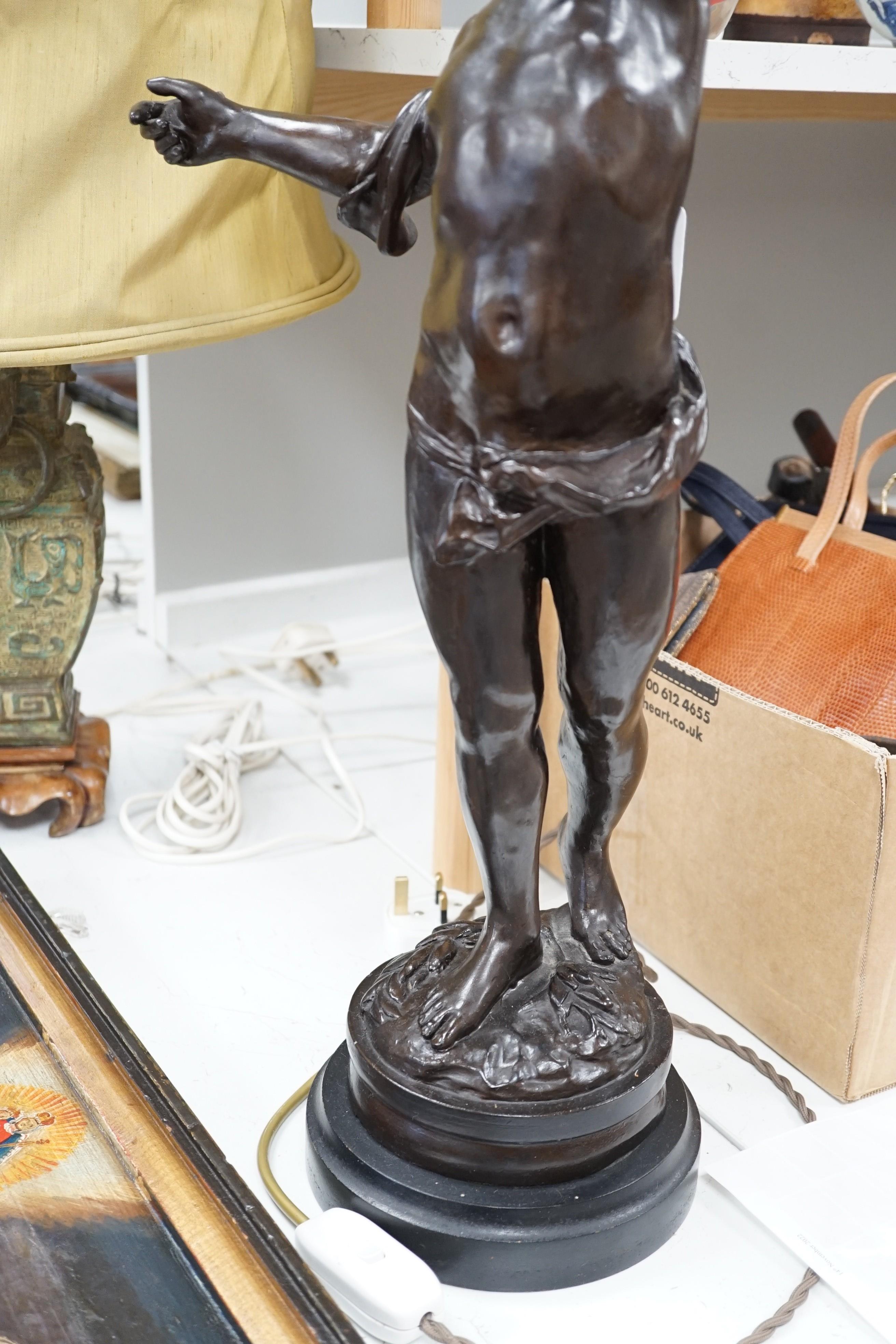 A bronzed composition cherub table lamp with frosted glass shade Height 88 cm.